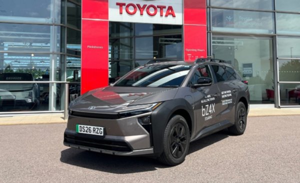 Toyota bZ4X electric SUV parked outside a dealership.