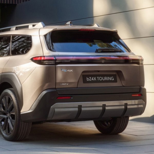 Rear view of a bronze SUV with a bZ4X TOURING badge.