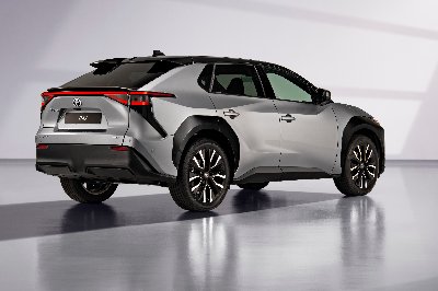 Silver SUV with black roof shown from rear-side angle.