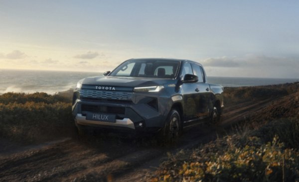 Toyota Hilux driving off-road near the coast.