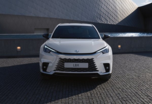 Front view of a white Lexus LBX parked on a cobblestone surface.