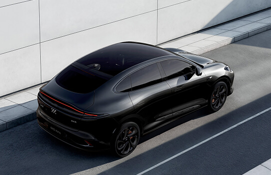 A black electric SUV parked on a paved street.