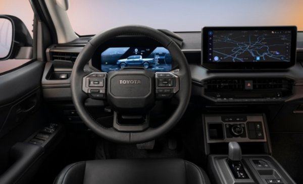 Car interior showing steering wheel, digital dashboard, and navigation screen.
