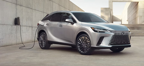 Silver SUV plugged into a charging station.