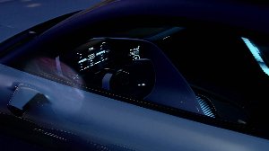 Side view of a car interior with illuminated dashboard at night.