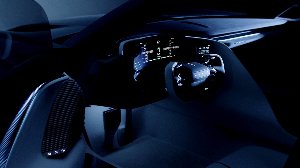 Futuristic car interior with digital dashboard and illuminated controls.