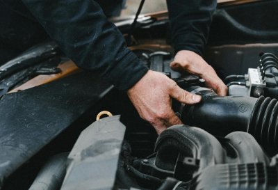 Mechanic's hands working on a car engine.