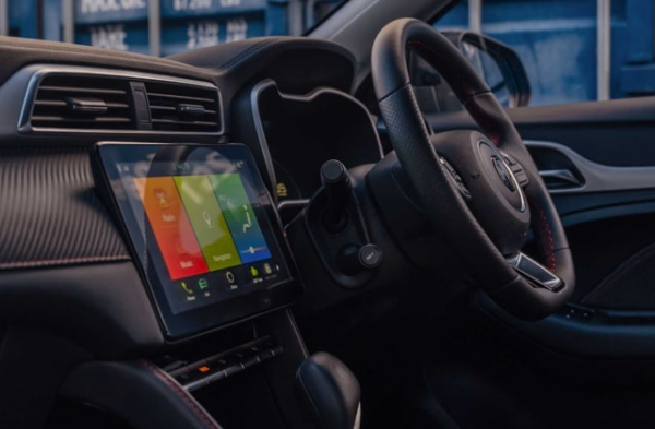 Interior of a car showing steering wheel and touchscreen display.