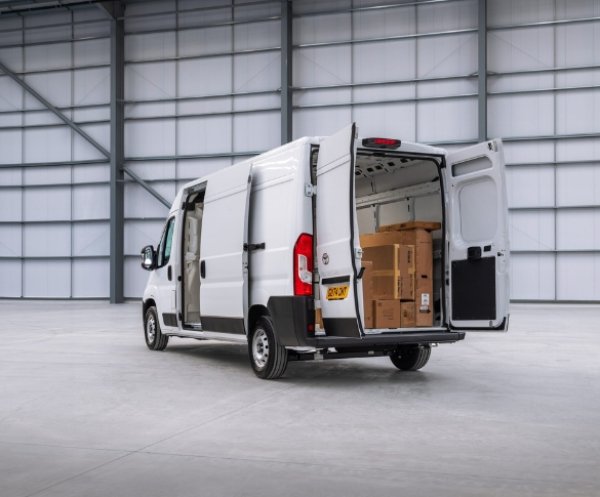 White van with open rear doors showing boxes inside.