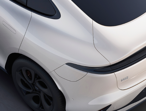 Rear view of a white electric car with black trim and tinted windows.