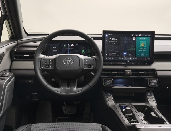 Interior view of a Toyota car dashboard with a digital display and steering wheel.
