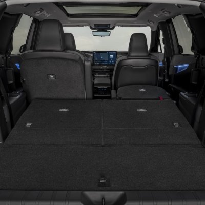 Folded rear seats of a car, showing extended boot space and front seats visible.