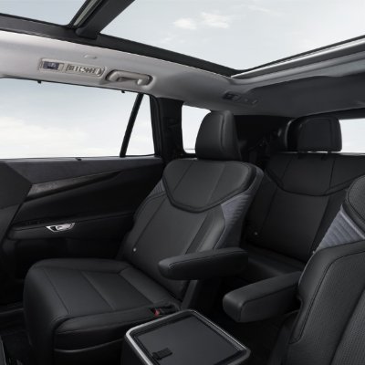 Black car interior showing leather seats and panoramic sunroof.