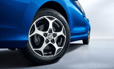 Close-up of a blue car's front wheel with alloy rim and black tyre.