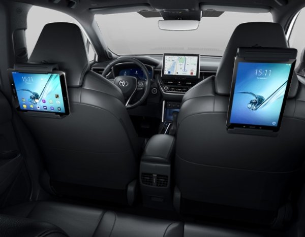 Tablets mounted on the back of car seats with navigation and apps displayed on screens.