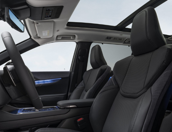 Interior of a car showcasing front seats and panoramic sunroof.