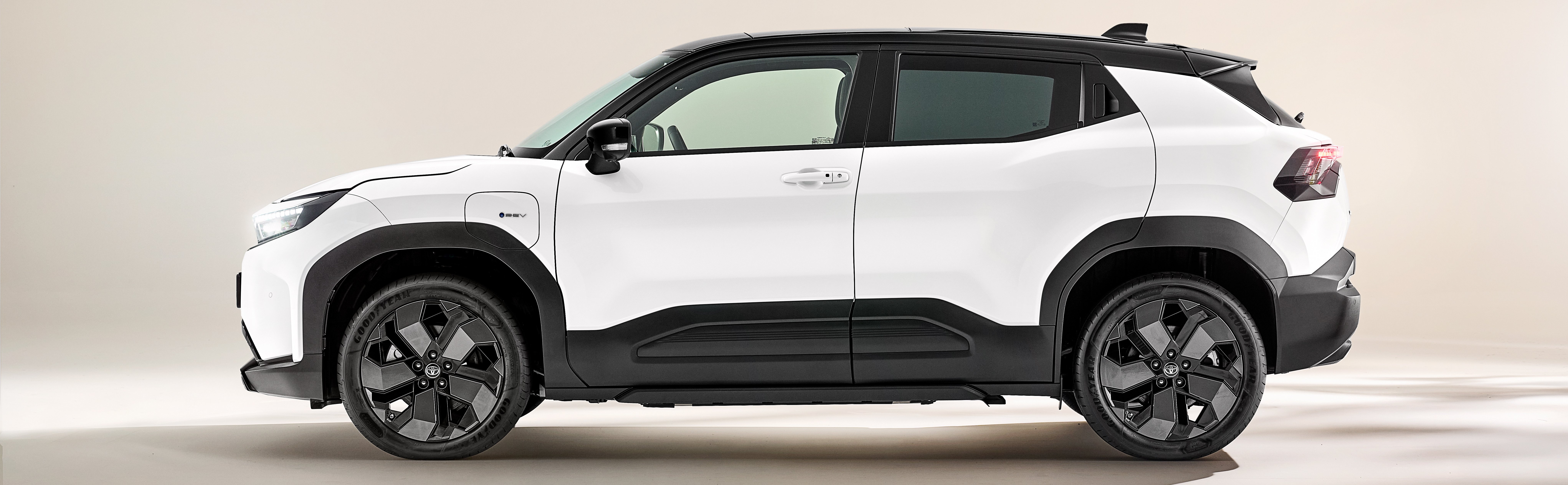 Side view of a white SUV with black accents.