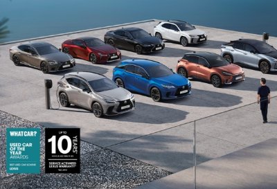 A selection of Lexus cars parked on a stone surface with a person standing nearby.