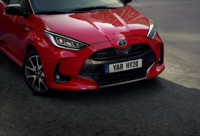 Red Toyota car with registration plate YAR HY20 on the road.